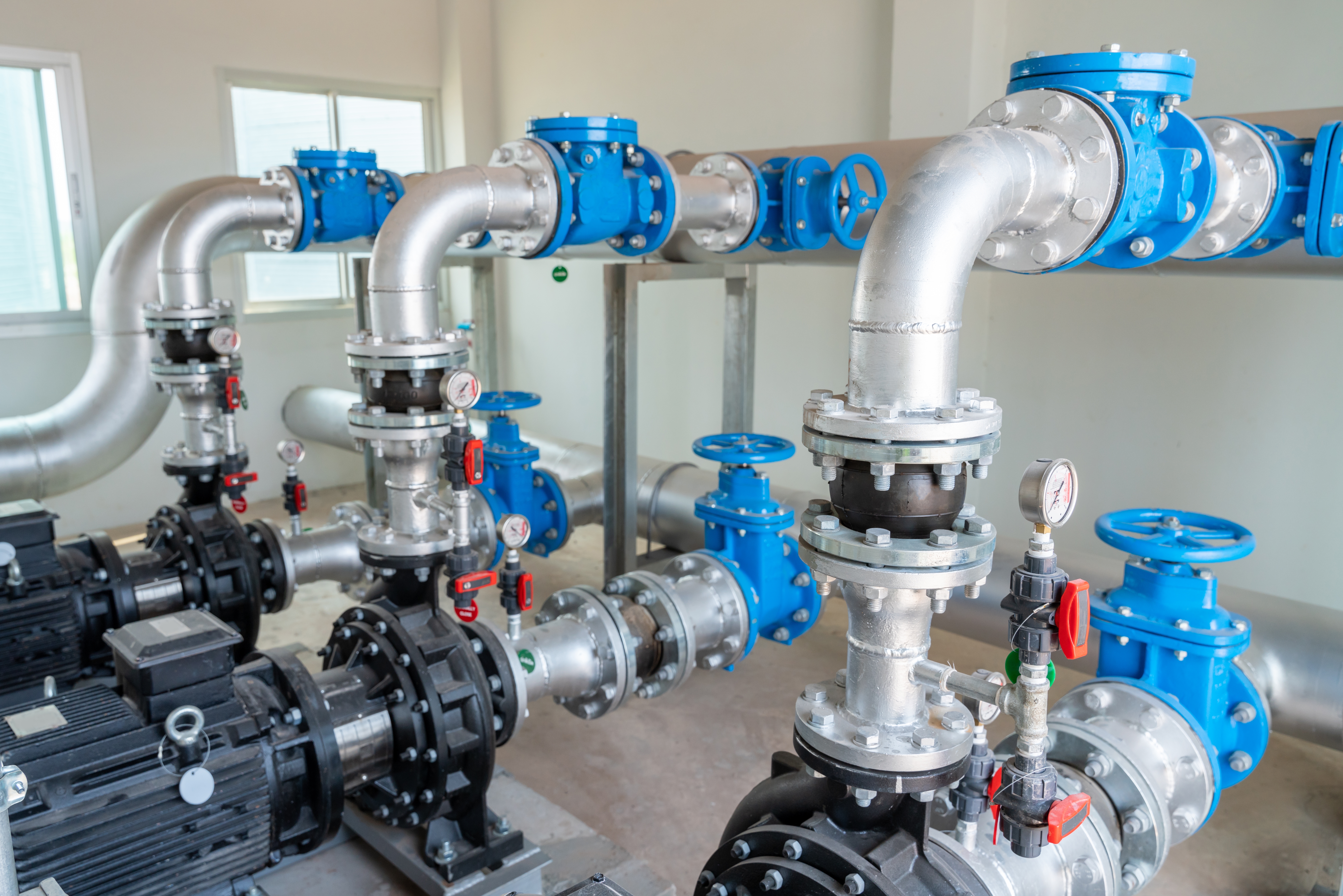 Process piping, valves, and pumps inside a water facility